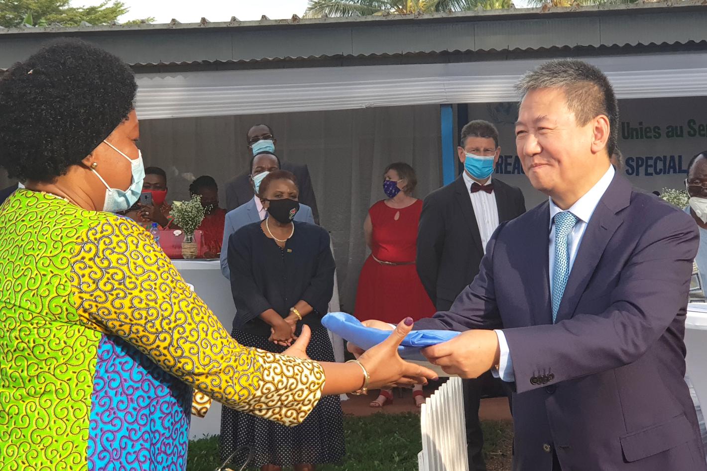 Special Envoy Huang Xia hands lowered flag.